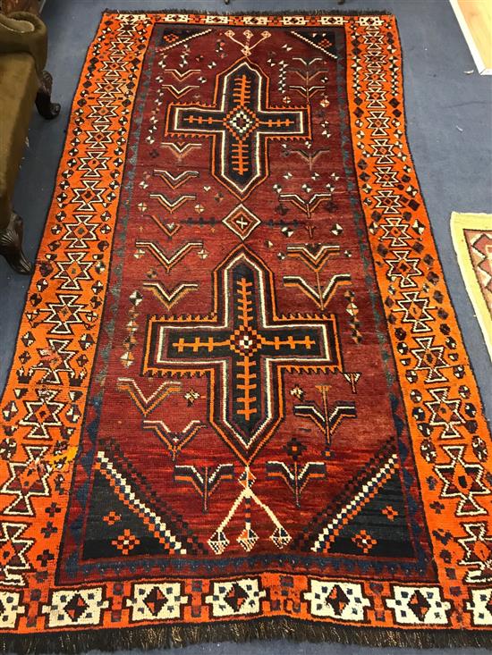 A red ground Shiraz rug 265 x 139cm